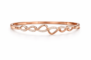 Rose gold bracelet with infinity design on a white background