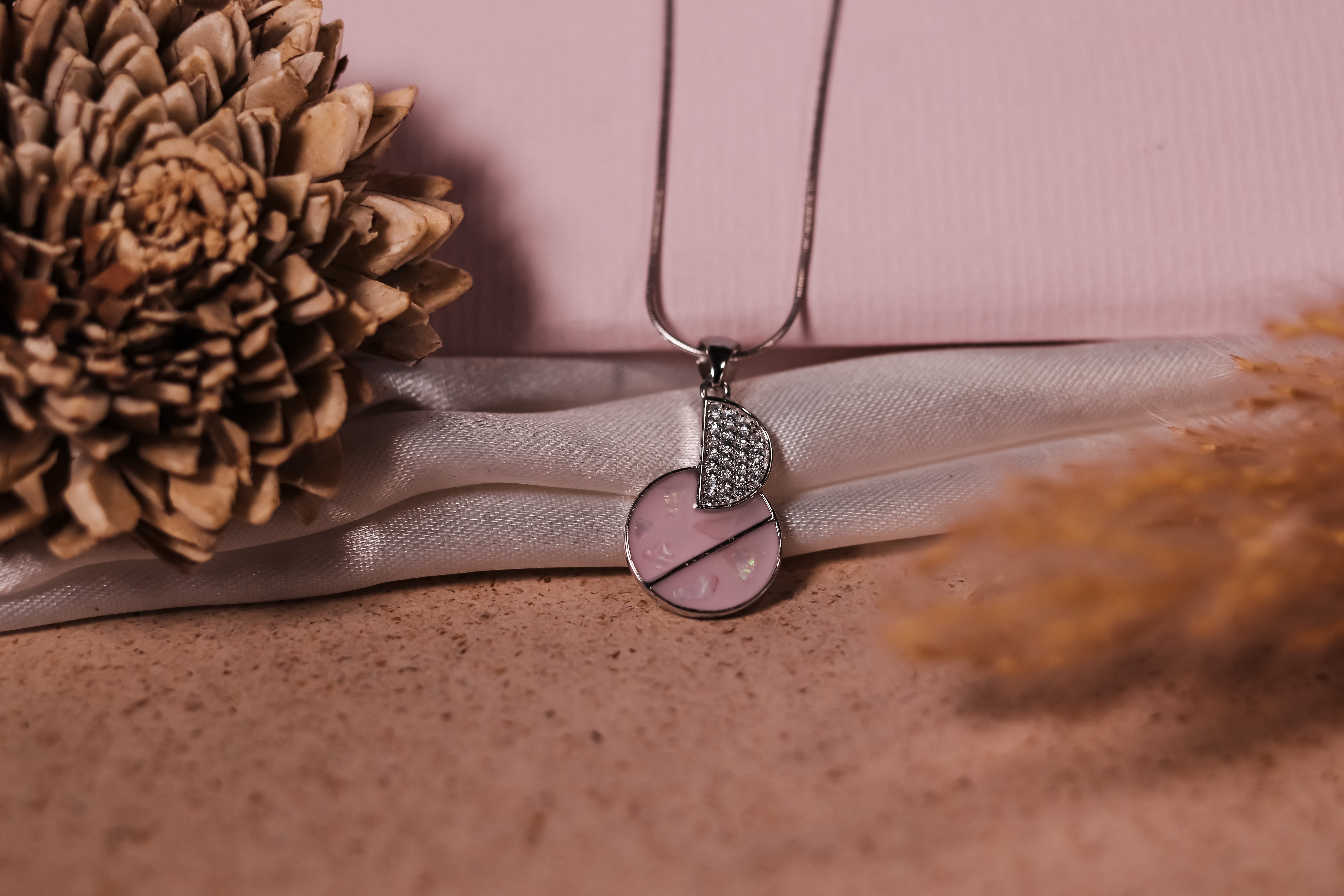 Half-pink enamel, half-studded crystal design on a Sleek chain